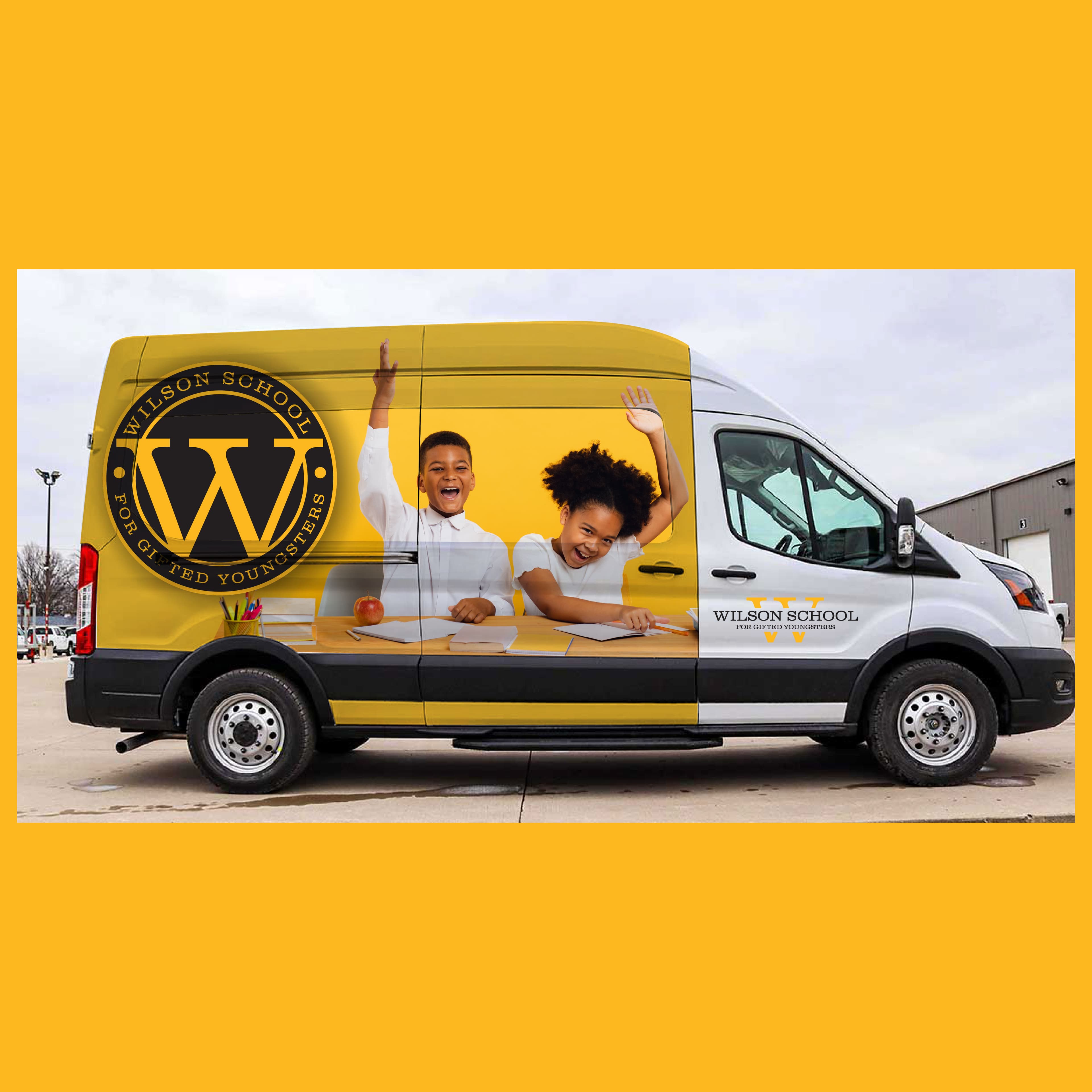Brown delivery van wrapped with Wilson School District graphics, parked outside the Grizzly Graphics shop in Lilburn